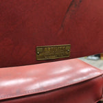 RED PLEATHER CHAIR W/METAL LEGS