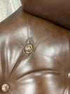 BROWN LEATHER BOLSTERED ARMCHAIR