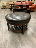 BROWN LEATHER ROUND OTTOMAN W/WOOD BASE