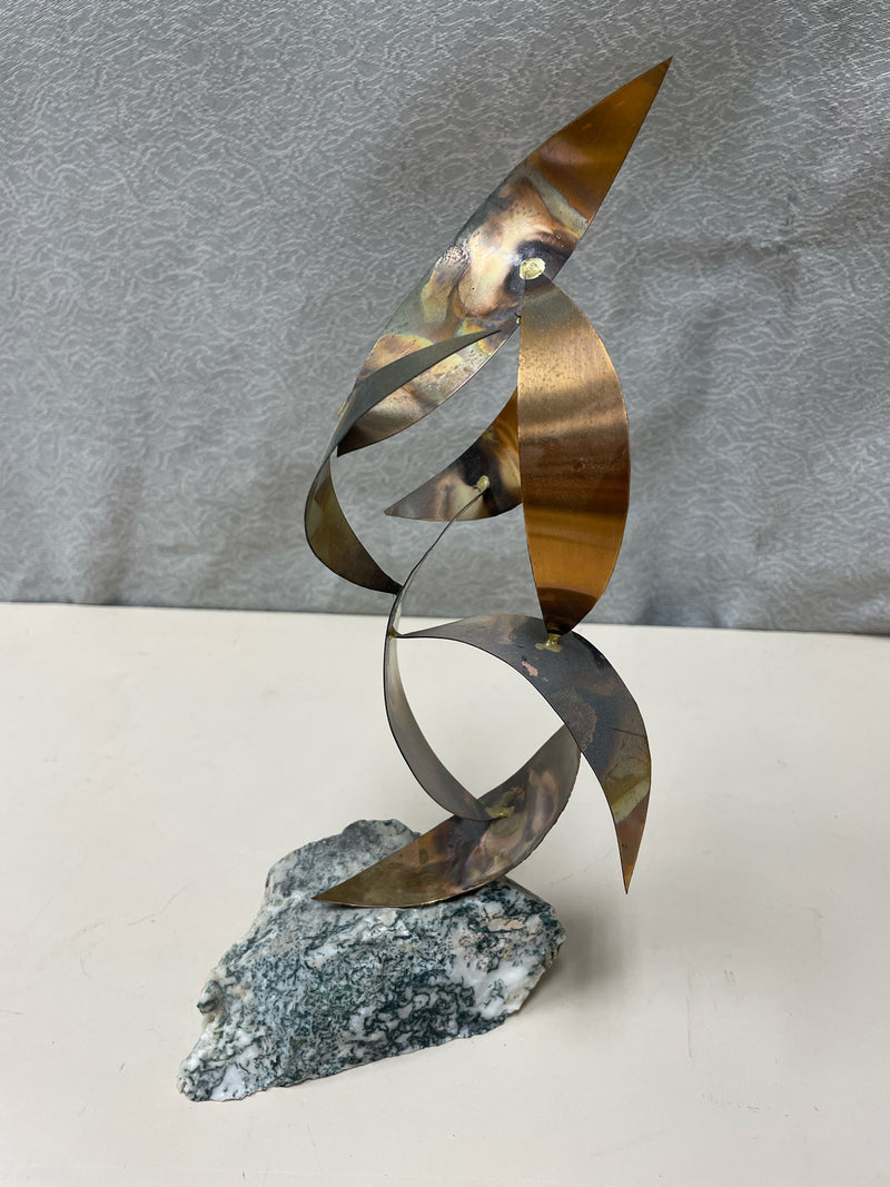 METAL RIBBONS SCULPTURE ON STONE