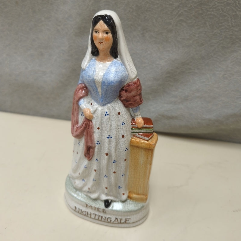 WOMAN W/BOOKS CERAMIC FIGURINE