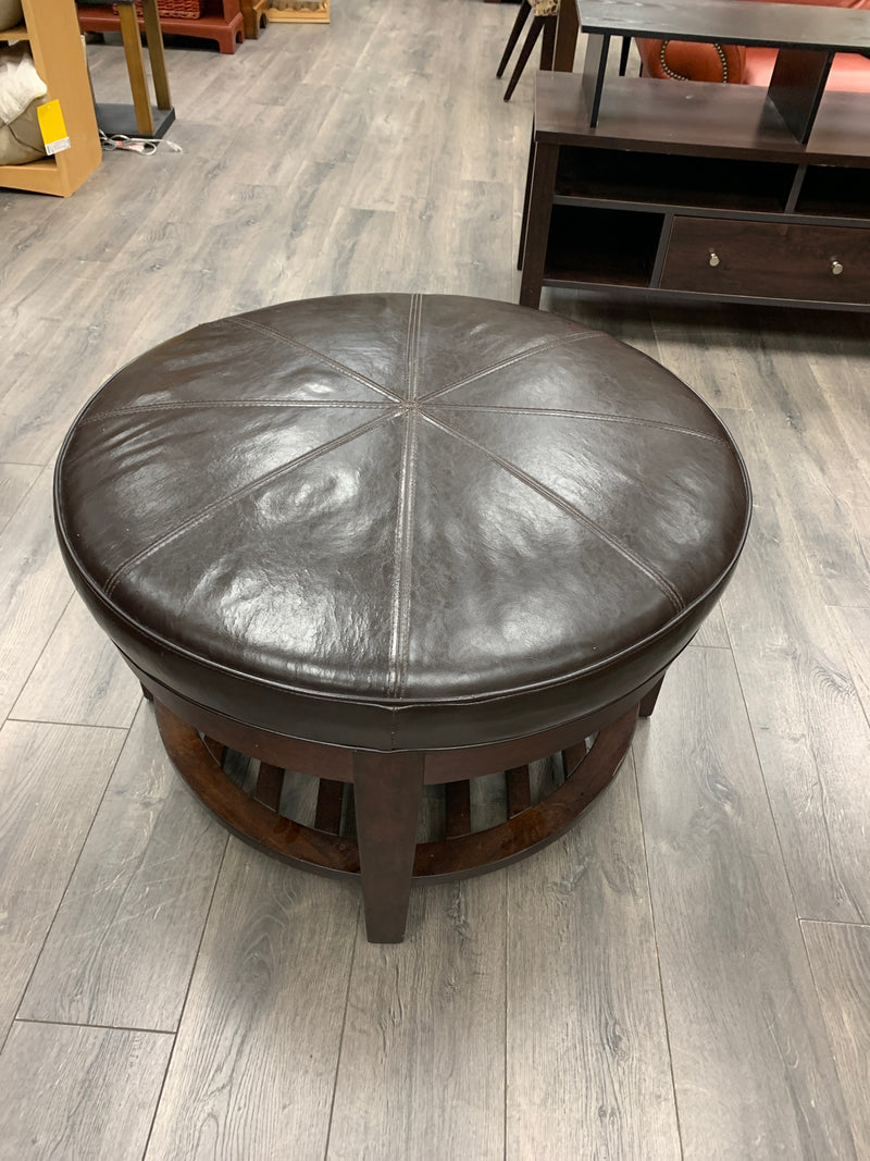 BROWN LEATHER ROUND OTTOMAN W/WOOD BASE