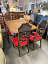 CARVED TABLE W/6 RATTAN CHAIRS W/RED UPHOL