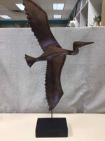 BROWN METAL BIRD ON WOOD STAND