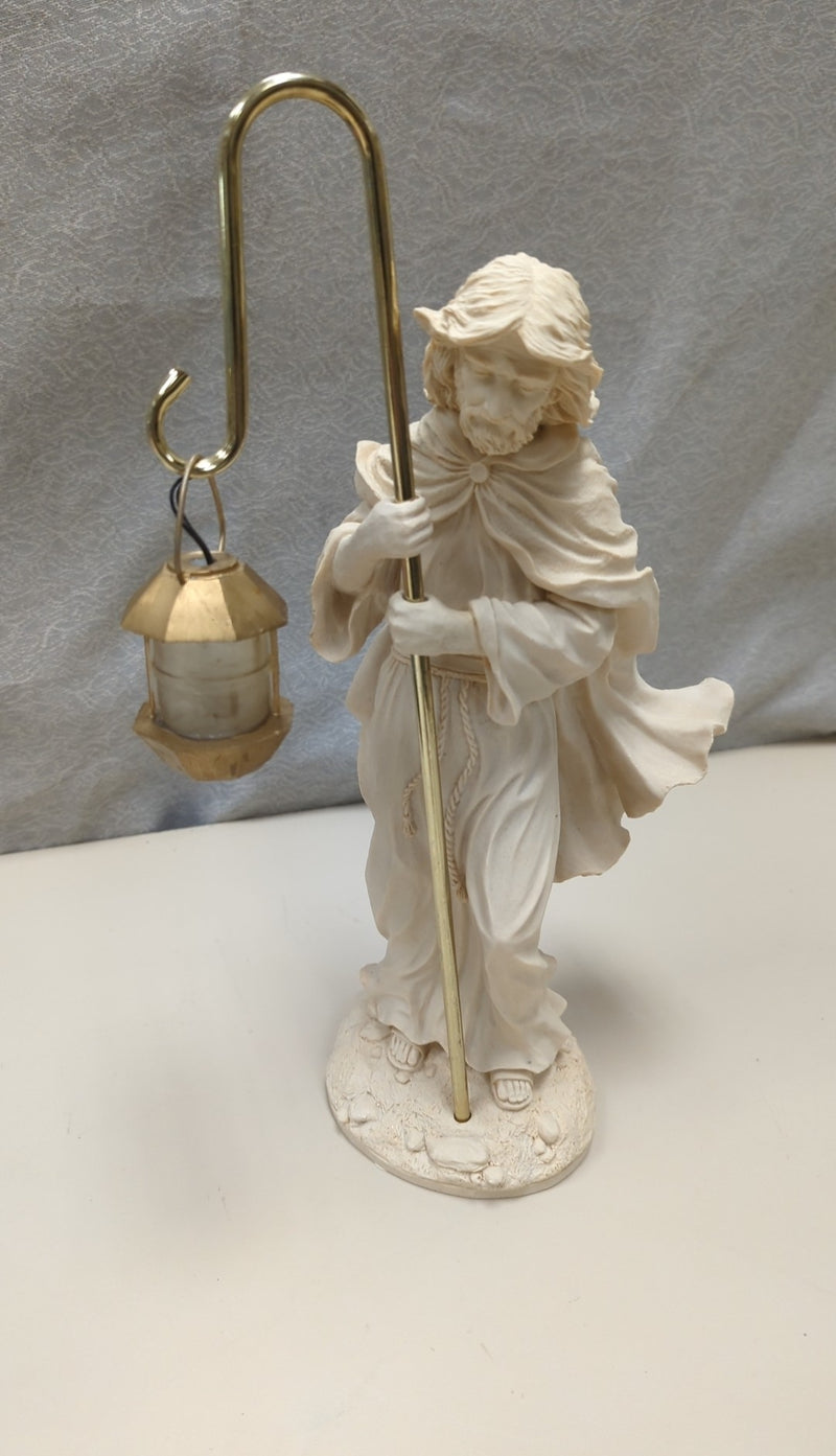 HOLY FIGURE HOLDING LANTERN