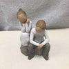 2 PEOPLE SITTING TOGETHER FIGURINE