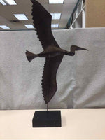 BROWN METAL BIRD ON WOOD STAND