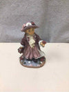 GIRL HOLDING TRUNK FIGURINE