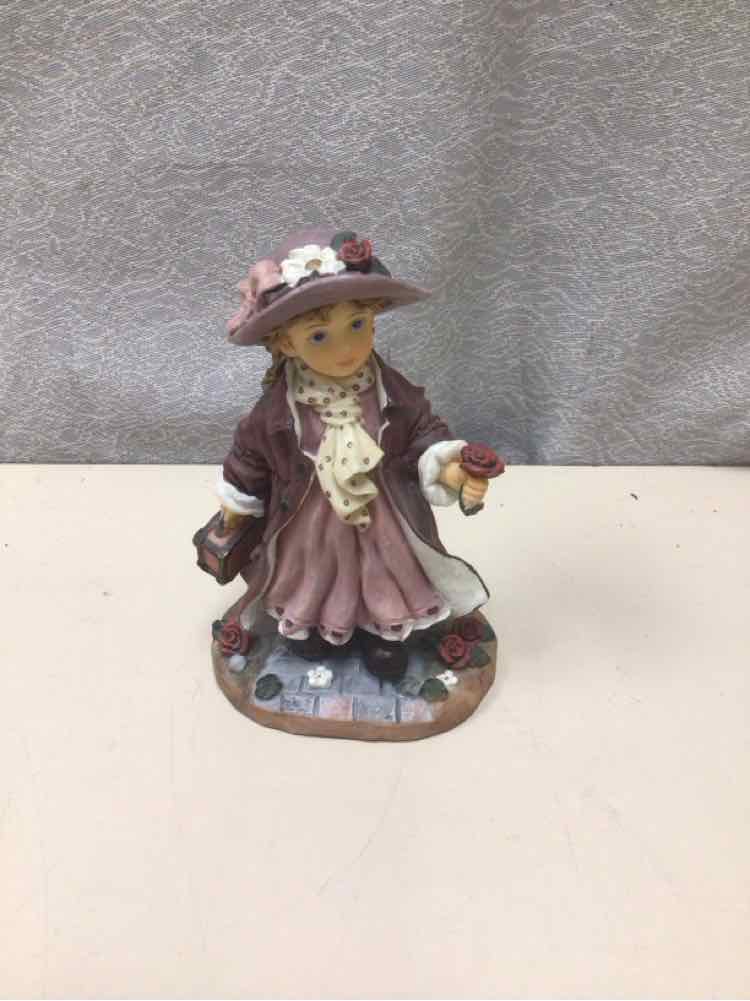 GIRL HOLDING TRUNK FIGURINE