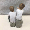2 PEOPLE SITTING TOGETHER FIGURINE