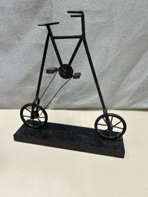 BLACK TALL METAL BICYCLE ON STAND