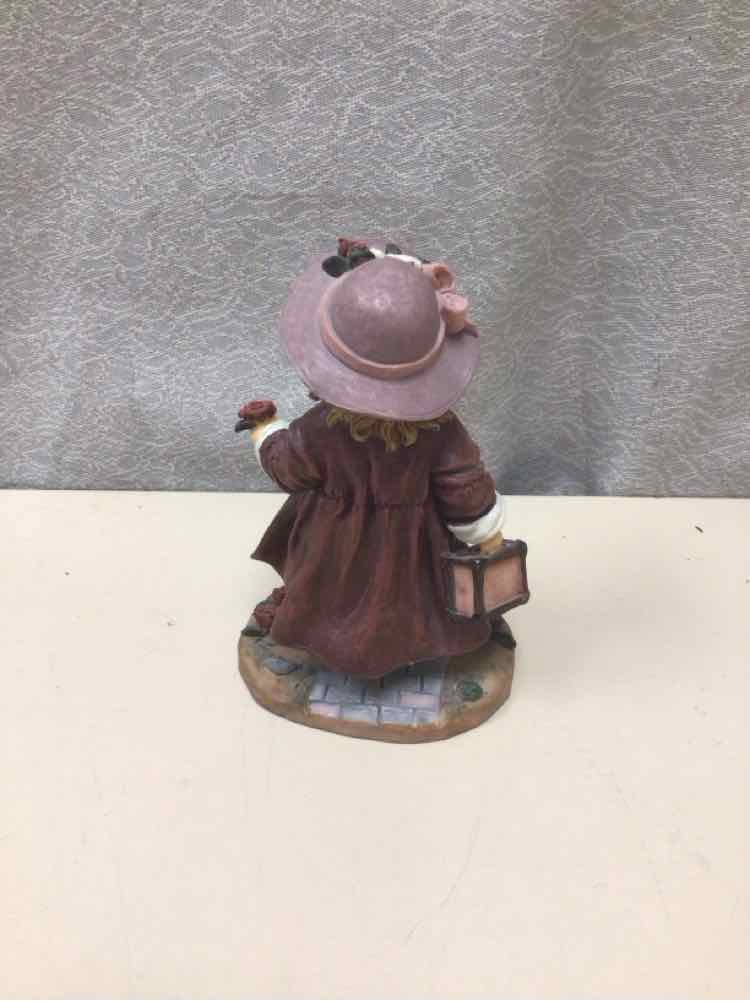 GIRL HOLDING TRUNK FIGURINE