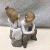 2 PEOPLE SITTING TOGETHER FIGURINE