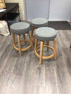 3 GREY UPHOLSTERY STOOLS WITH WOOD LEGS
