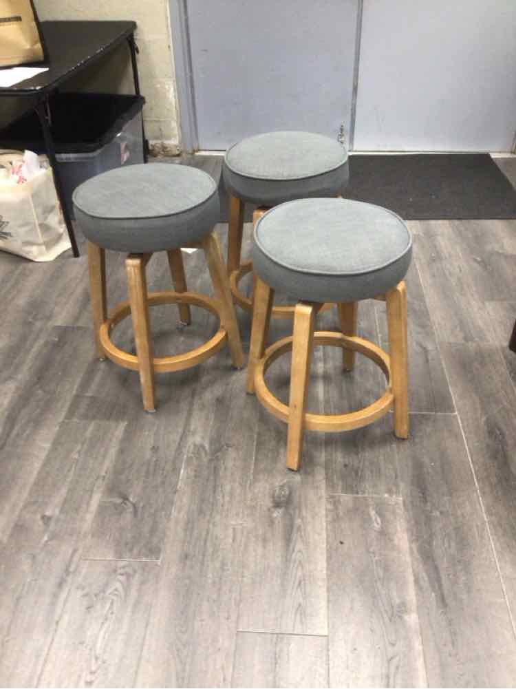 3 GREY UPHOLSTERY STOOLS WITH WOOD LEGS