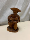 WOOD CARVED STATUE OF CHILD DRINKING