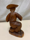 WOOD CARVED STATUE OF CHILD DRINKING
